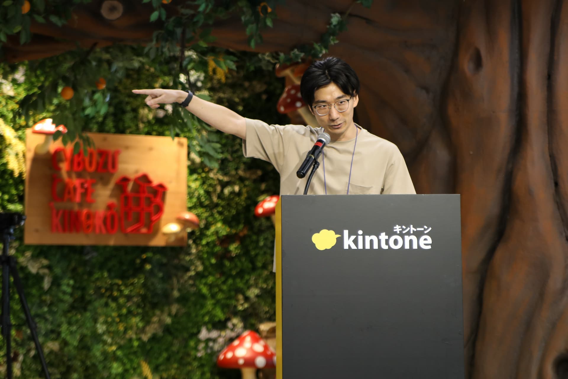 予選会で発表している志太の様子。壇上で話しながらスクリーンを指差している。